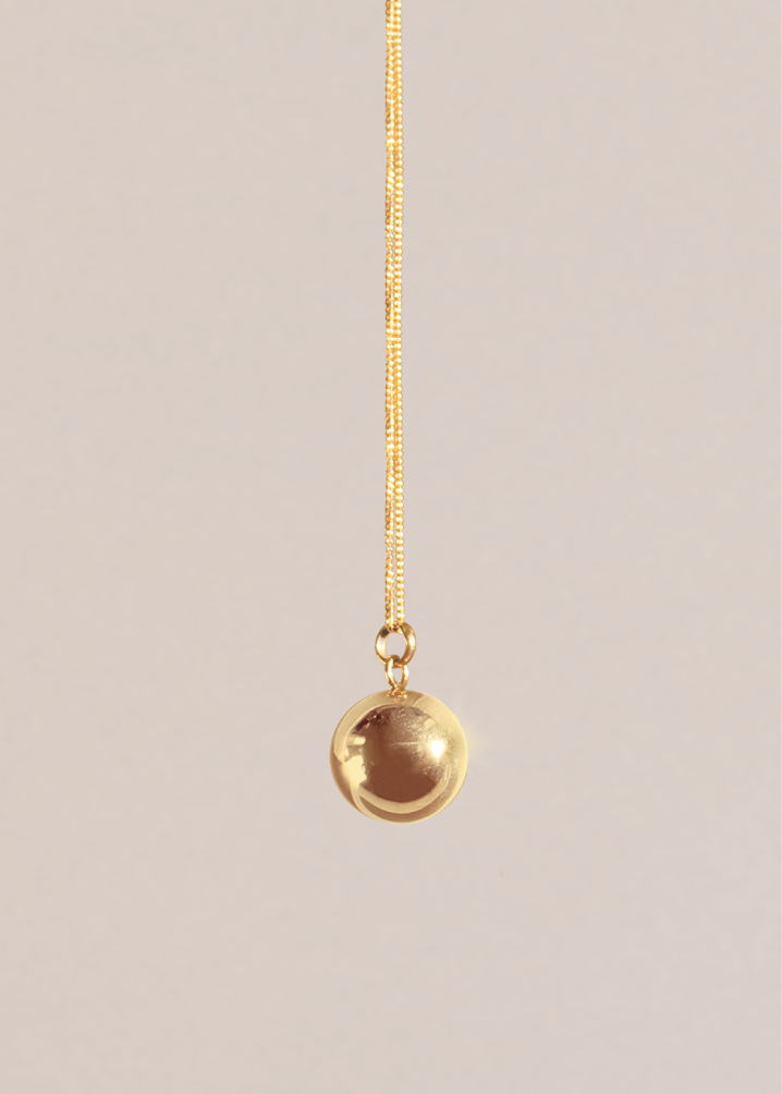 Yellow gold chain and bola hanging